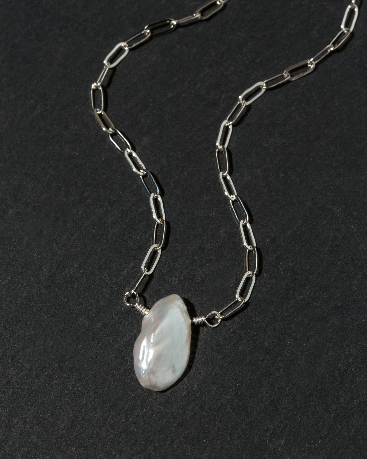 A silver paperclip chain necklace with  irregular Keshi pearl pendant.