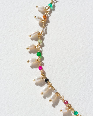 Detail shot of colorful gemstone beads and pearl drops.