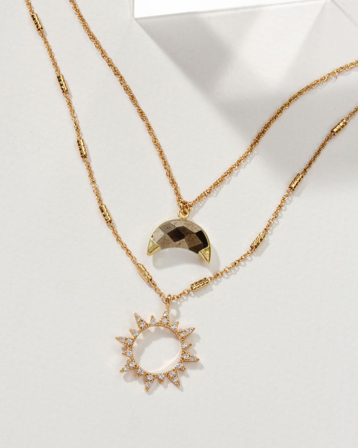 Live by the Sun, Love by the Moon gold necklace set with moon and sunburst pendants