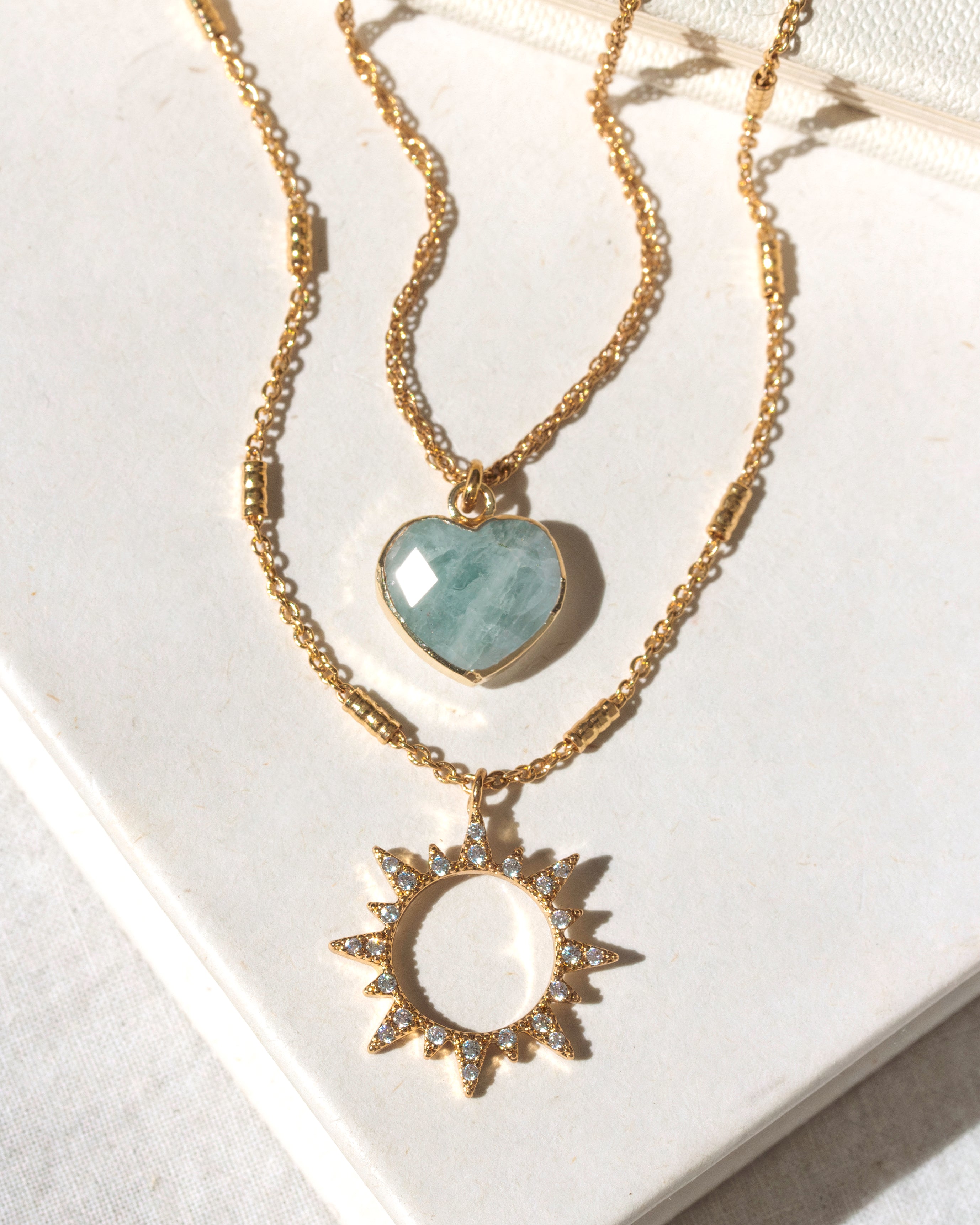 Gold necklace set with aquamarine heart and clear CZ sun charm pendant