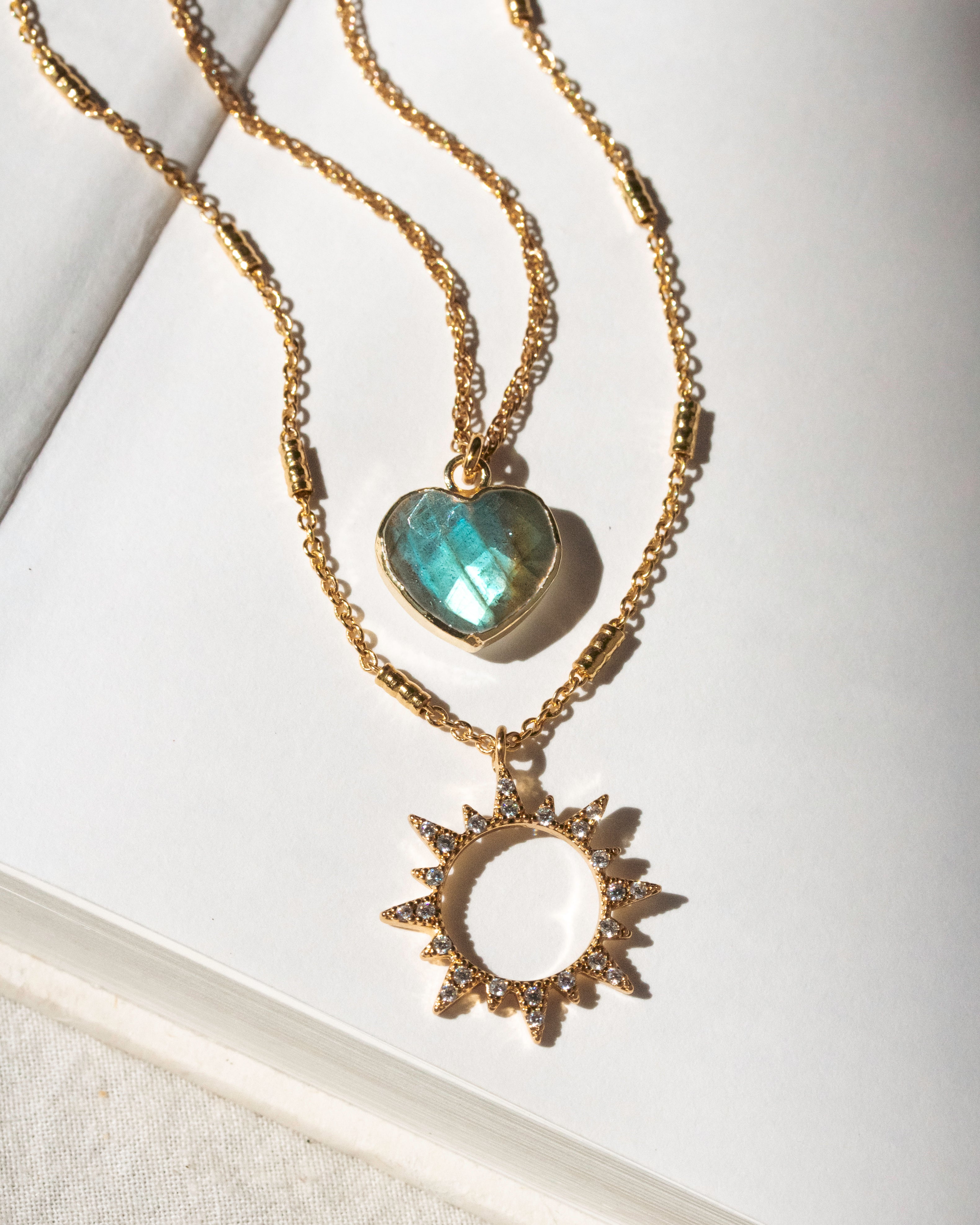 Gold layering necklace set with labradorite heart and clear CZ sun charm pendants