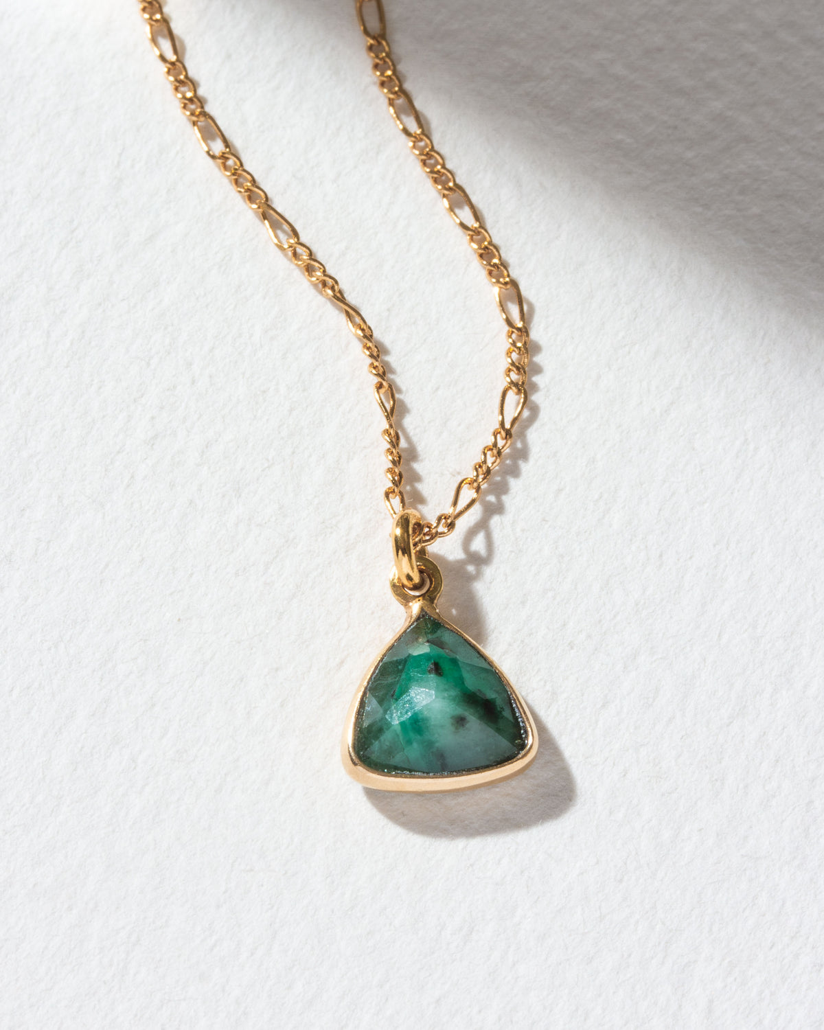 Detail of triangular emerald pendant necklace