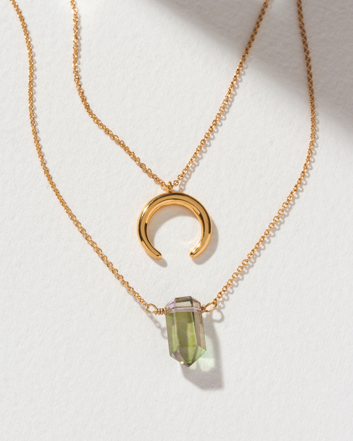 Gemstone Point Necklace Set, featuring a Mystic Quartz and crescent pendant on gold chains.