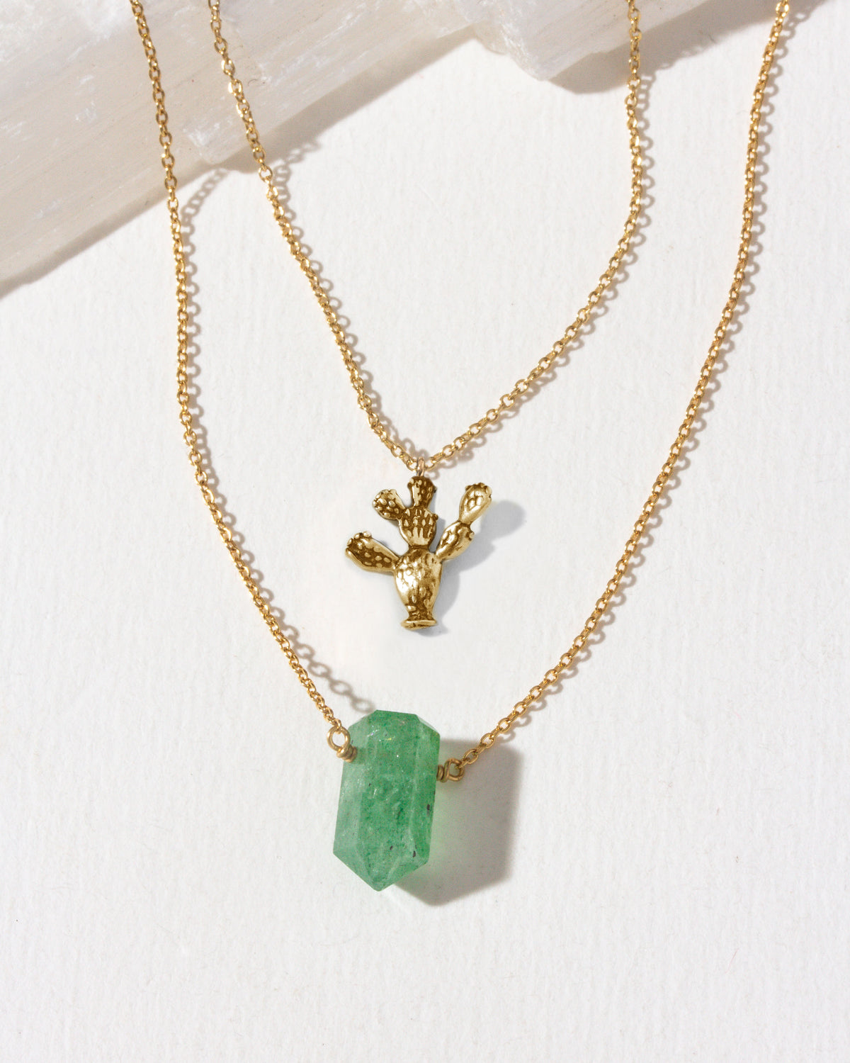 Gold layering necklaces with a green aventurine and gold prickly pear cactus pendant