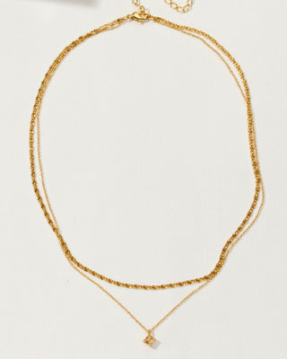 A gold-toned double-strand necklace with opal charm.