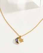 A delicate gold chain necklace featuring a labradorite crescent moon and star pendant.