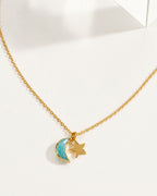 A delicate gold chain necklace featuring a amazonite crescent moon and star pendant.
