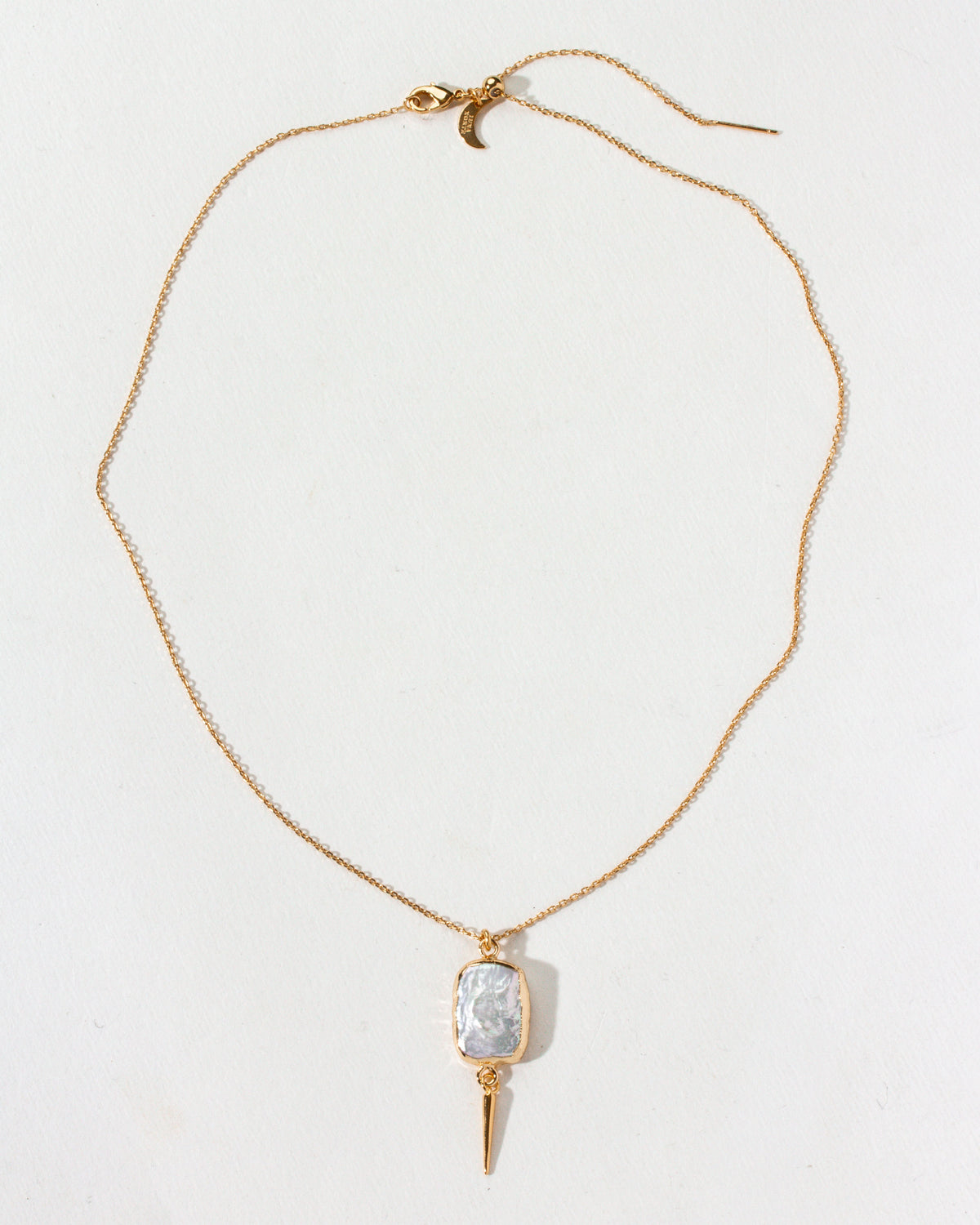 Gold chain necklace featuring a freshwater pearl pendant with a gold spike accent.