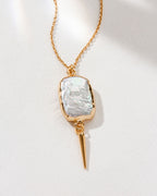 Gold chain necklace featuring a freshwater pearl pendant and quill accent.