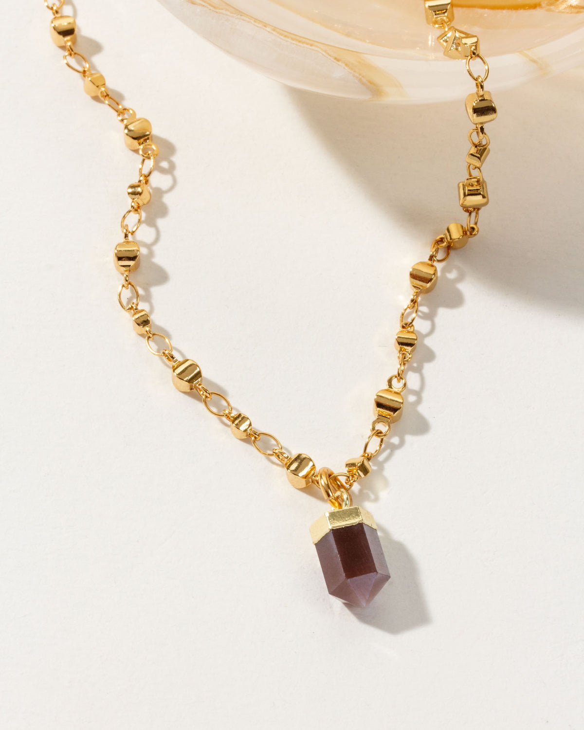 Gold chain necklace featuring a Smoky Quartz point pendant.
