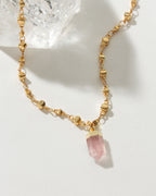 Gold necklace featuring a Rose Quartz point pendant.