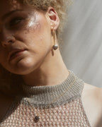 Model wearing coffee moonstone heart necklace.