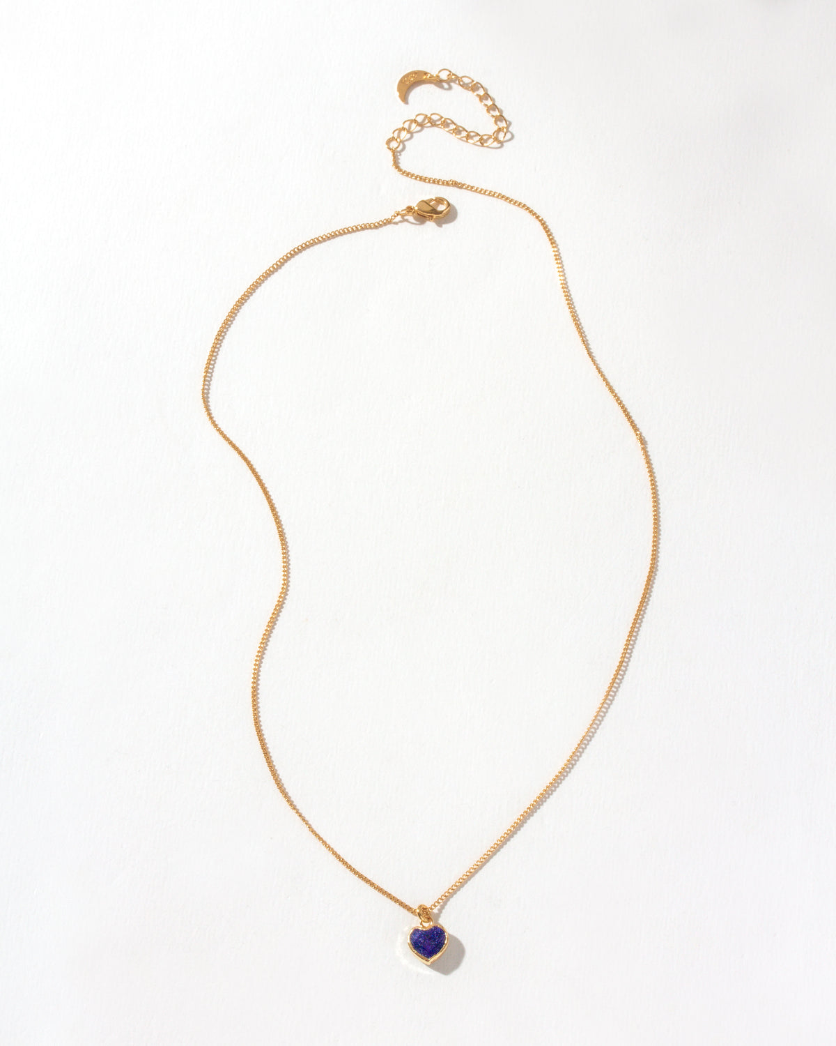 Gold chain necklace featuring a Sapphire heart-shaped gemstone pendant.