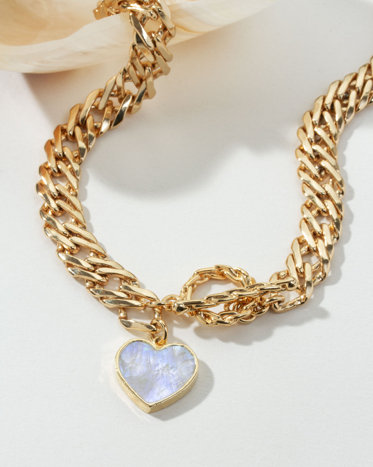 Gold chain necklace with a Moonstone heart pendant and a toggle clasp.