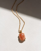 Necklace with a sunstone stone pendant on a light background