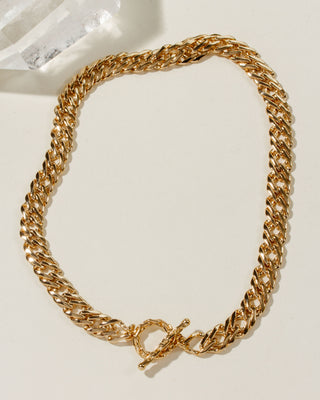 A gold-toned chunky curb chain necklace with a toggle clasp.