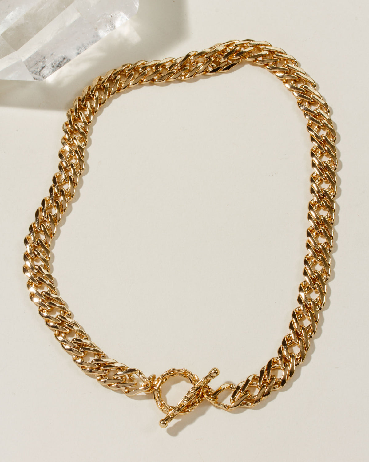 A gold-toned chunky curb chain necklace with a toggle clasp.