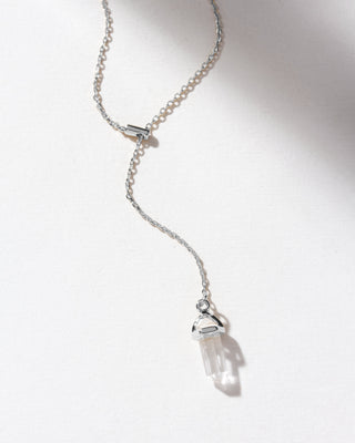 A silver chain necklace with a clear crystal pendant.
