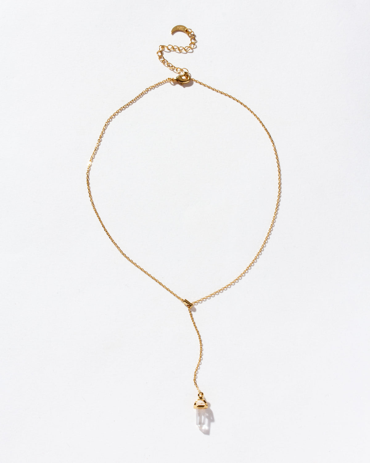 A Prism Point Lariat necklace with a clear quartz pendant and adjustable gold chain.