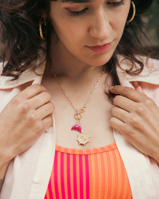 Woman models Capricorn Zodiac symbol gold plated toggle necklace with ruby crescent moon by Luna Norte