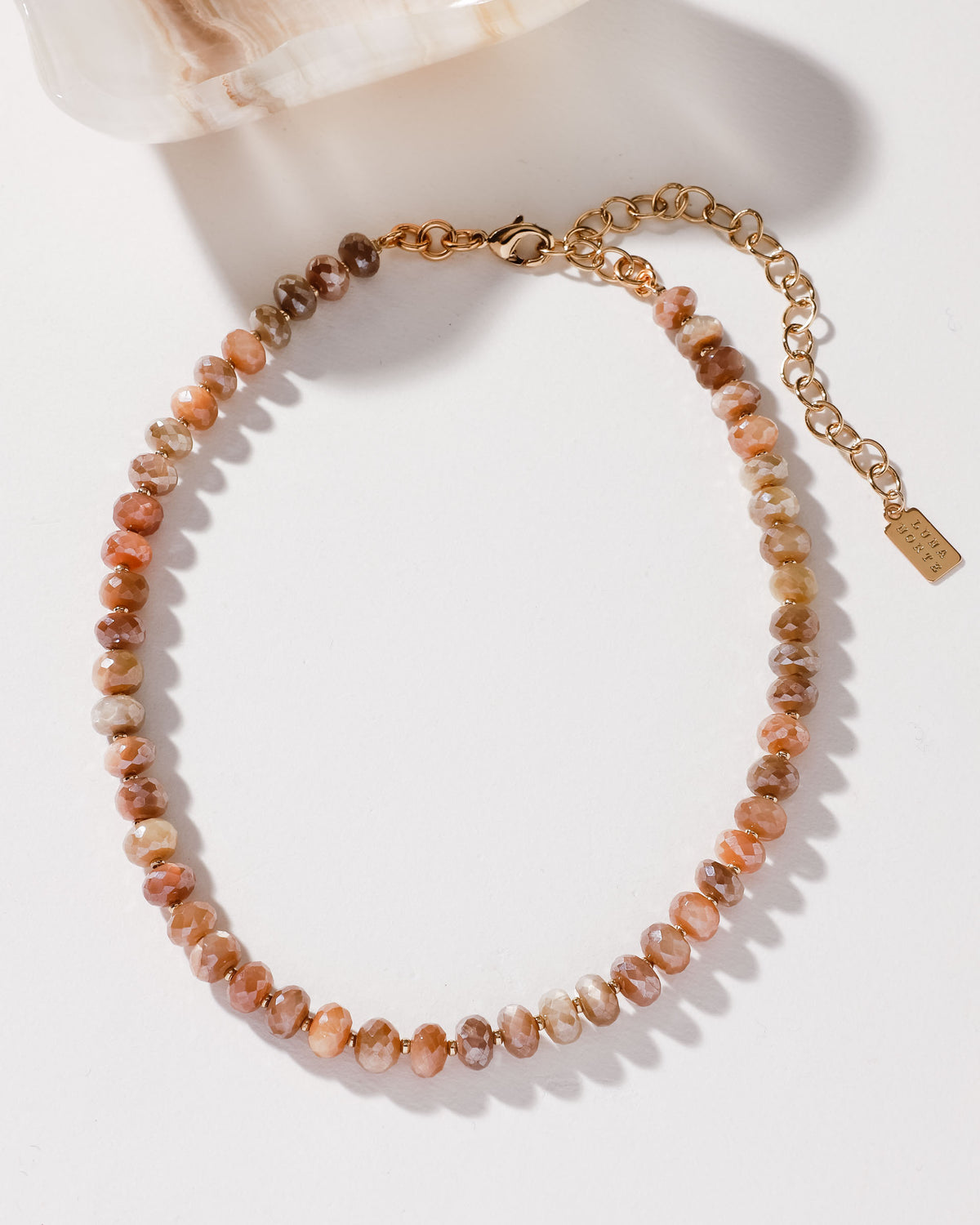 Beaded gold necklace and clasp, with coffee moonstone beads in varying shades of brown and peach.