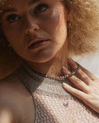 A person wears a Java Jewel Beaded Collar Necklace in Coffee Moonstone.