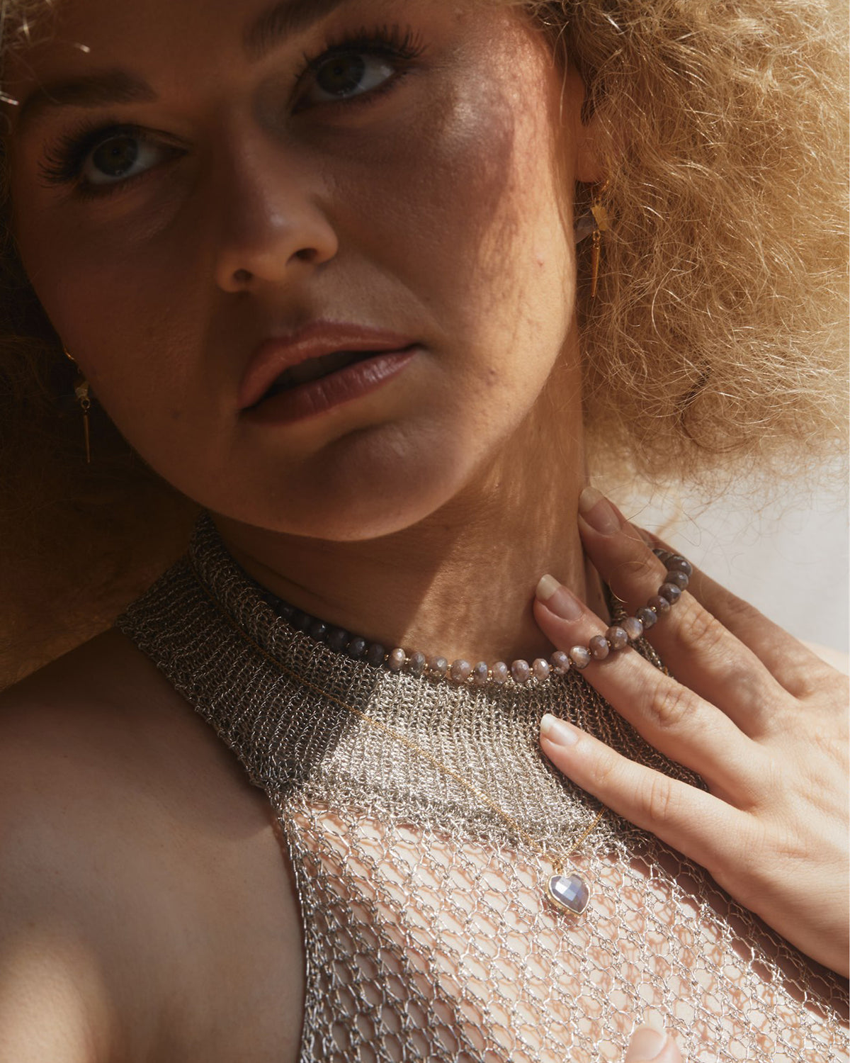 A person wears a Java Jewel Beaded Collar Necklace in Coffee Moonstone.