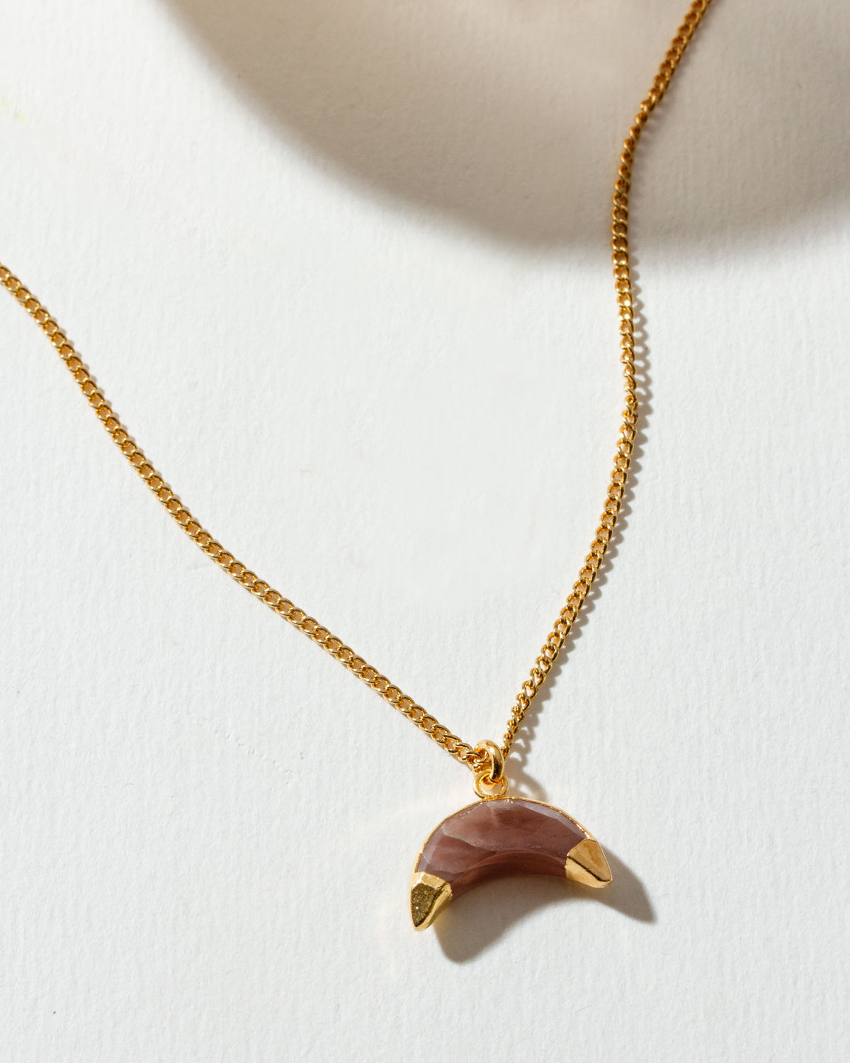 Gold chain necklace with a "coffee" moonstone pendant.