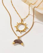 Gold-toned "Caffeine" necklace set with sun and "coffee" moonstone pendants.