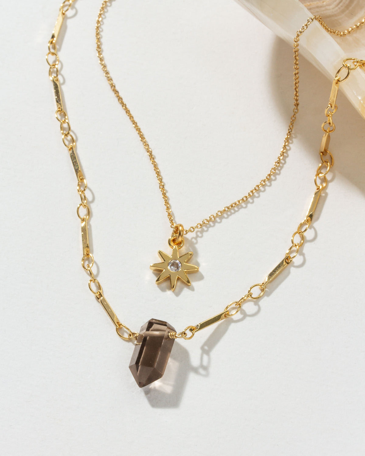 Shadows necklace set with smoky quartz and starburst pendant gold chains