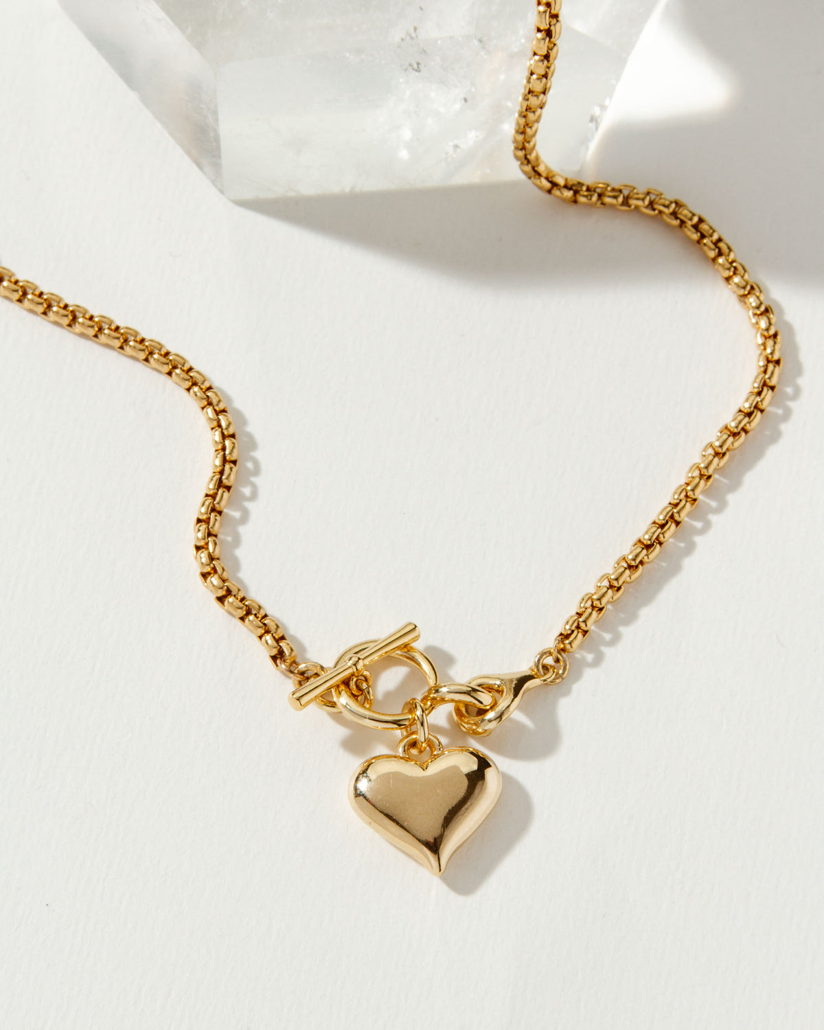 Gold popcorn chain necklace with a toggle clasp and puffy heart pendant.
