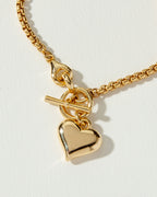 Gold popcorn-style chain necklace with a heart pendant and toggle clasp.