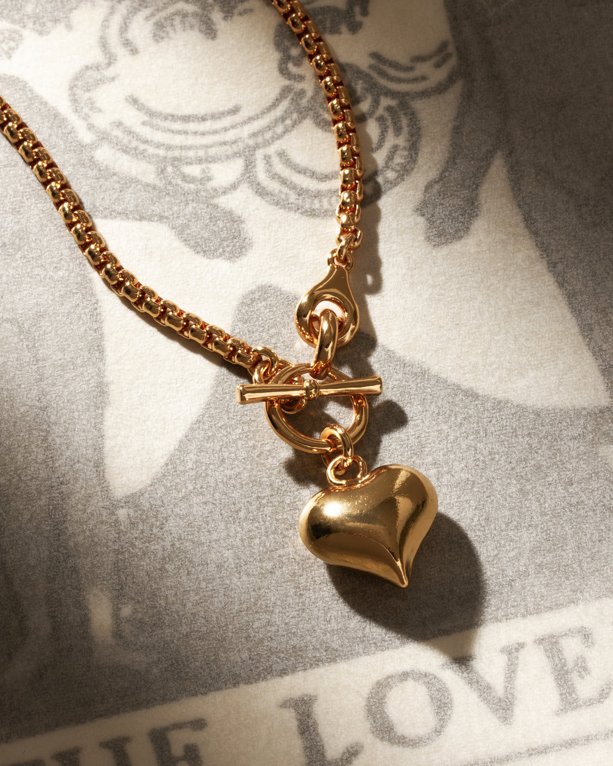 Gold, popcorn-chain Milano Amulet Toggle Necklace with puffy heart pendant and toggle clasp.