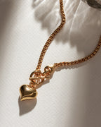 Gold popcorn chain necklace with toggle clasp and puffy heart pendant.