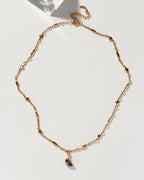 Dolce Luna necklace with a pyrite gemstone crescent on a gold chain.