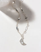 Silver 'Dolce Luna' necklace with a crescent gemstone pendant and star accents.