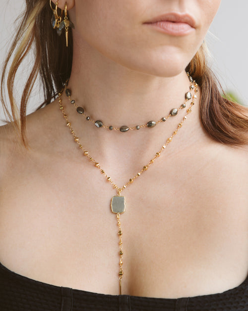 Eterno Amore Gemma Lariat Necklace in Pyrite, modeled with matching earrings.