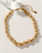 Titan's Gold beaded necklace, with brushed gold textured beads and an adjustable extender chain.