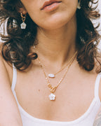 Golden Tulum Flora Toggle Necklace with Mother of Pearl flower and earrings.