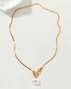 Golden Tulum Flora Toggle Necklace with a mother of pearl flower charm with a CZ center.