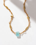 Gold chain necklace featuring an Aquamarine gemstone pendant.