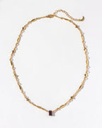 Gold chain necklace featuring a Ruby gemstone.