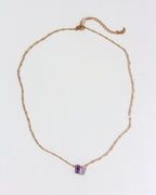Gold chain necklace featuring an Amethyst prism gemstone pendant.