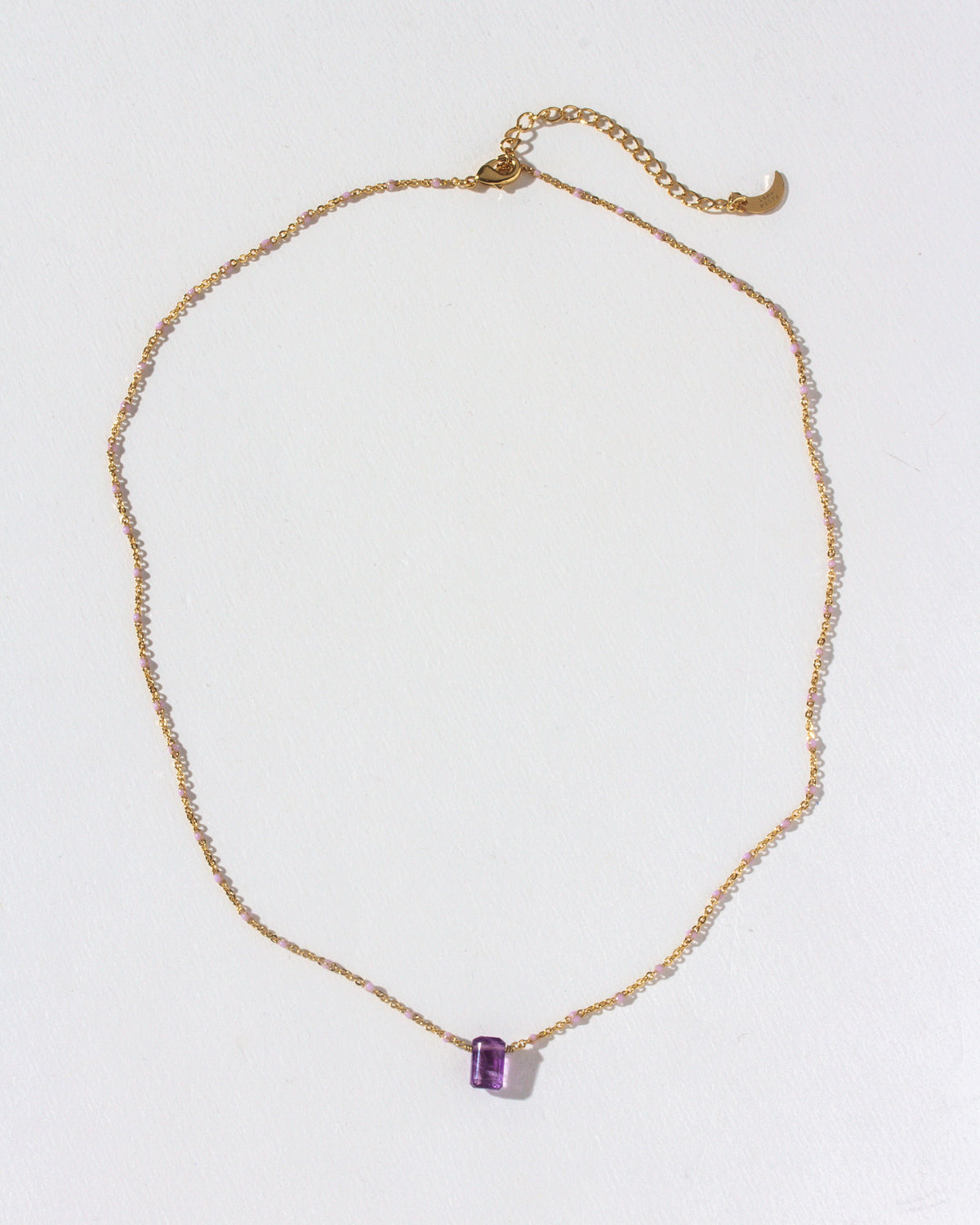 Gold chain necklace featuring an Amethyst prism gemstone pendant.