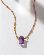 Prism Gems Birthstone Necklace featuring an Amethyst gemstone on a gold and pink beaded chain.