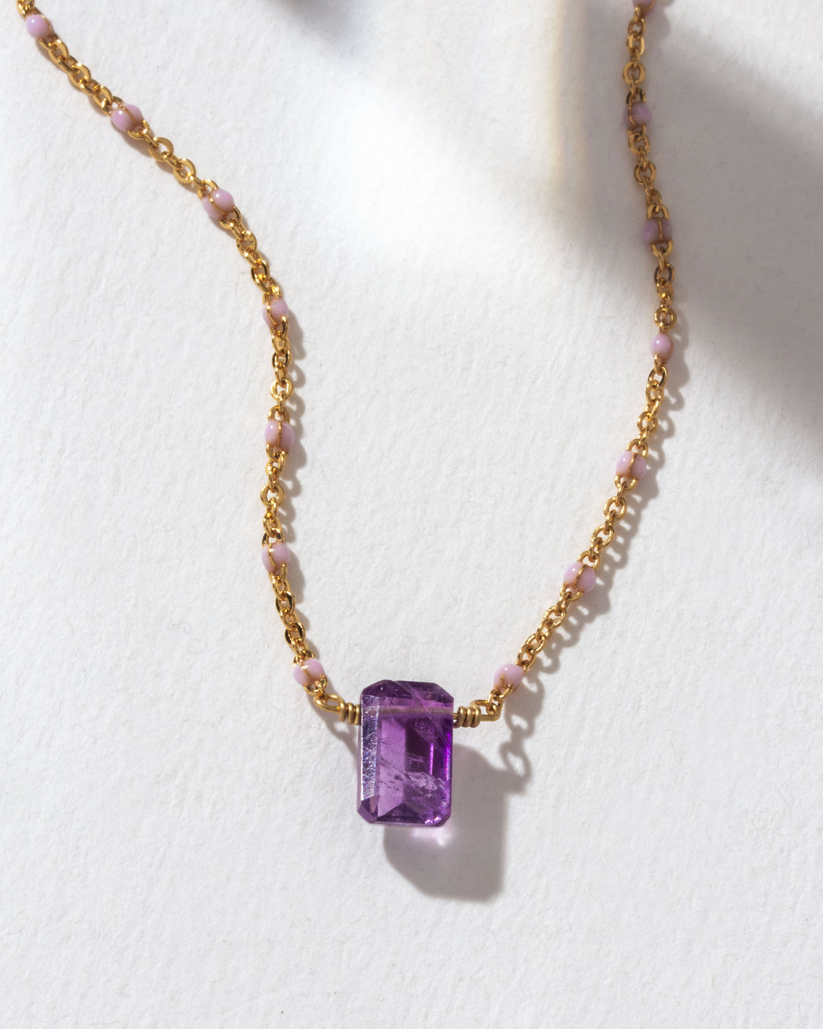 Prism Gems Birthstone Necklace featuring an Amethyst gemstone on a gold and pink beaded chain.