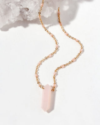 Necklace with a large pink opal crystal pendant on a white background