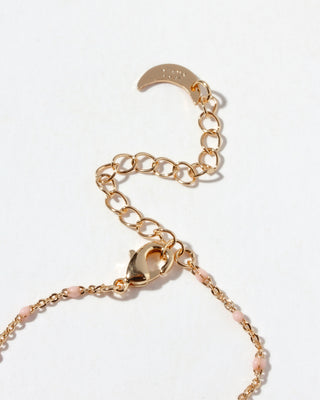 Closeup of gold necklace lobster clasp with a clasp on a white background
