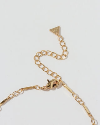 Closeup of lobster closure for gold necklace with triangular "Luna Norte" brand tab on extender.