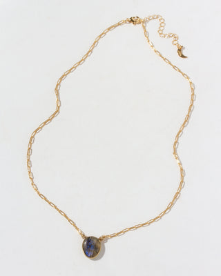 Gold necklace with a blue green labradorite stone pendant on a white background